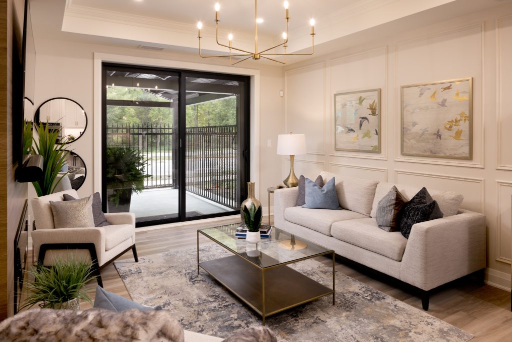 Bright modern living room featuring large glass doors onto patio.
